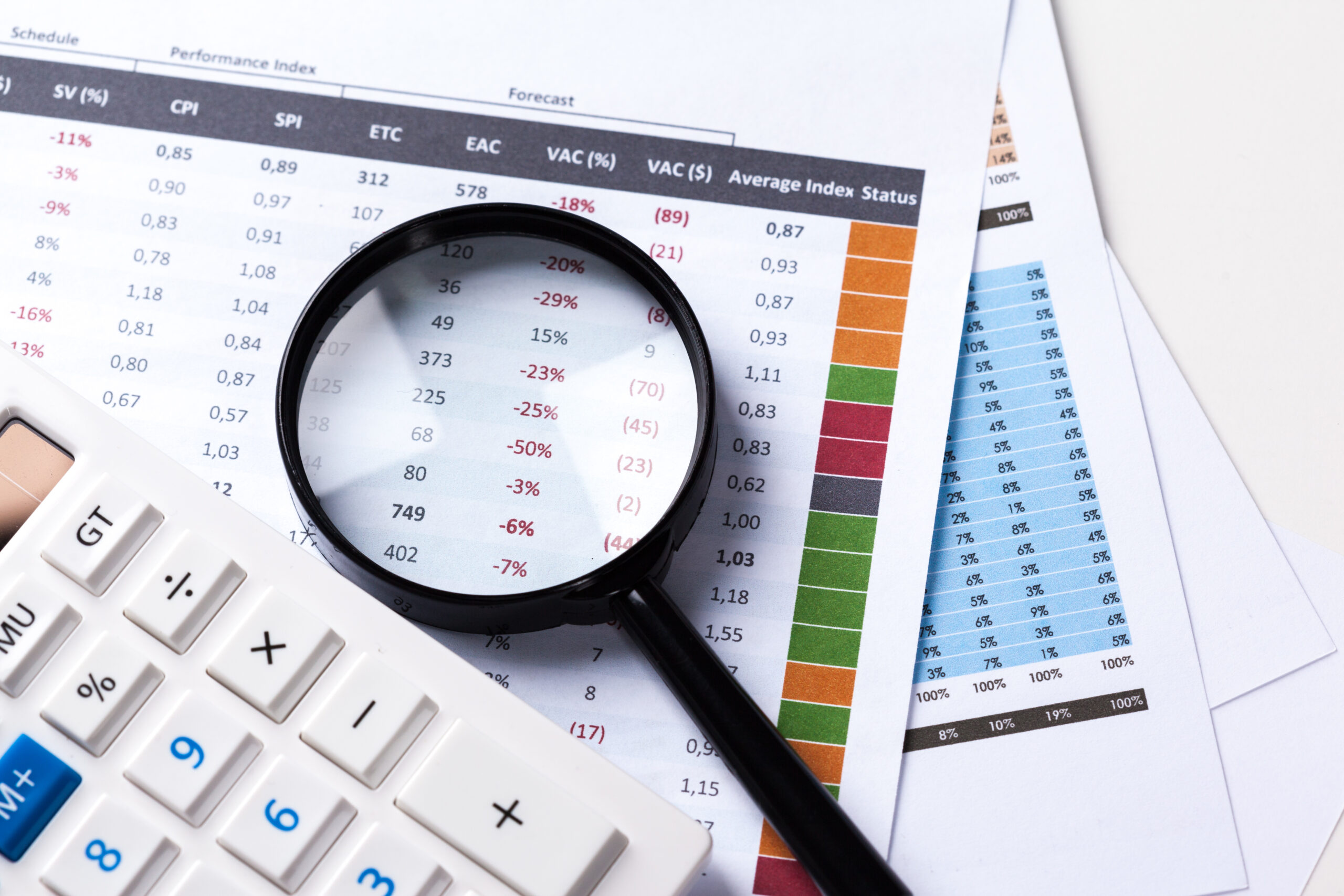 work with a magnifying glass, a calculator and papers work with a magnifying glass, a calculator and papers